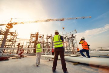 Civil engineer and safety officer inspection construction worker teamwork election steel truss in construction site